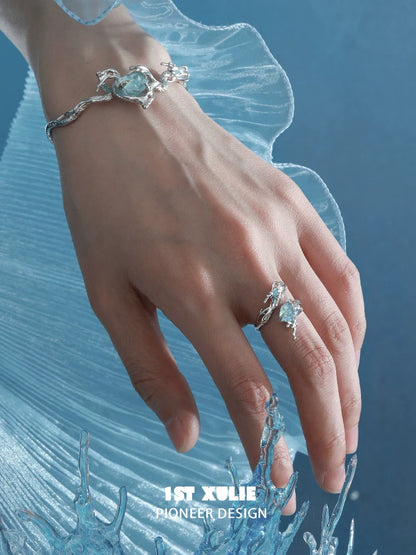 Elegant aquamarine dragon ring on a hand, showcasing intricate design and sparkling gemstone