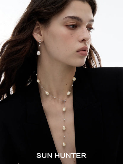 Elegant SUN HUNTER baroque pearl earrings showcased on a model with a sleek hairstyle