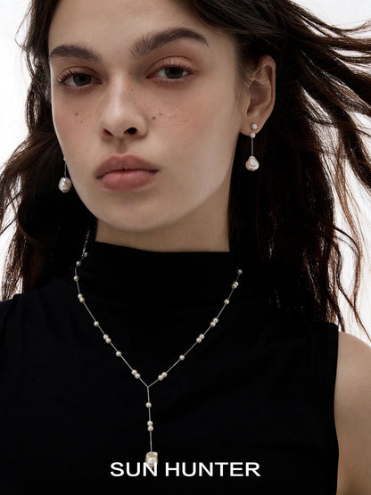 Elegant SUN HUNTER baroque pearl earrings dangling gracefully for a sophisticated look