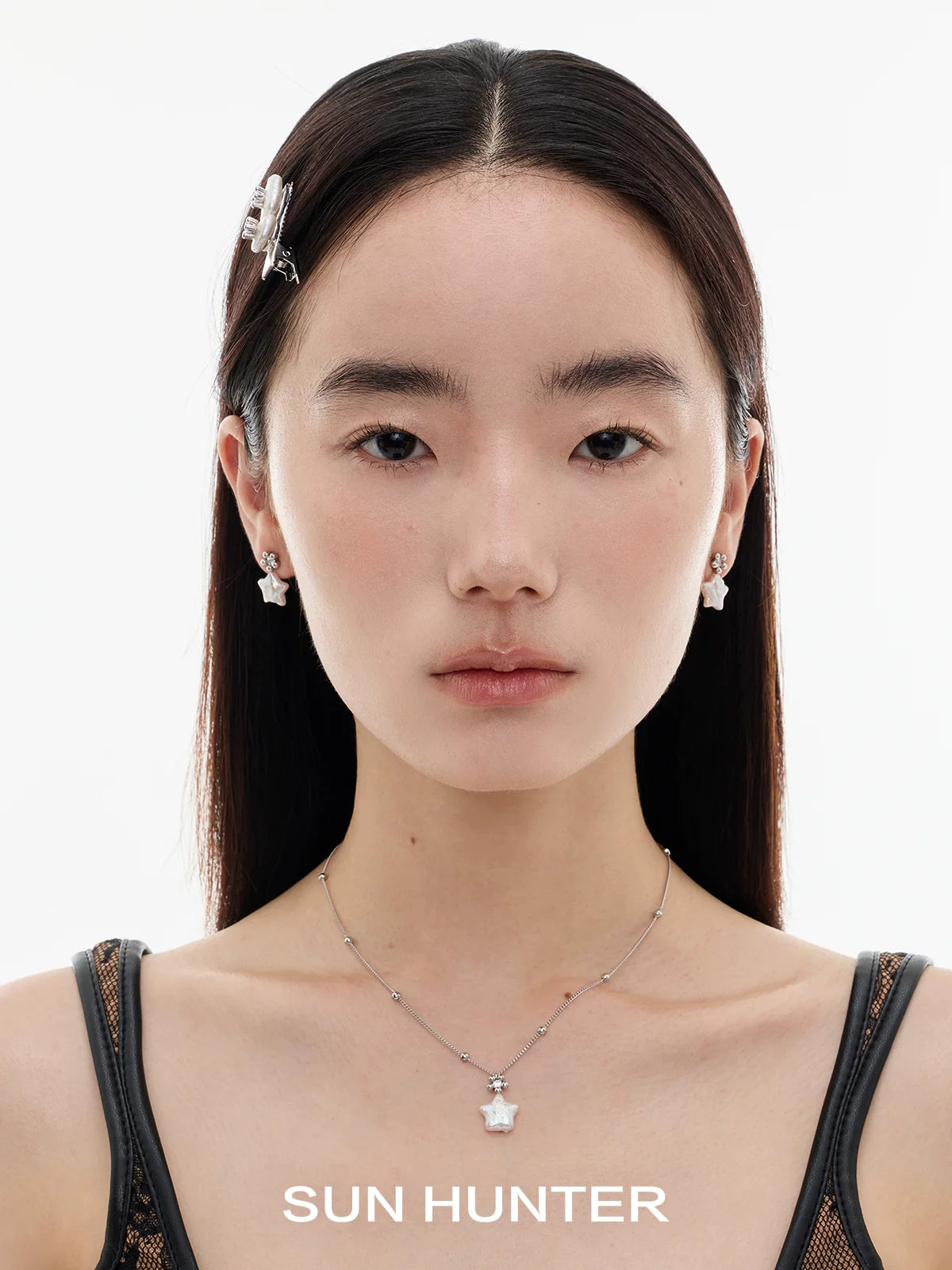 Elegant model wearing SUN HUNTER baroque pearl star earrings showcasing a unique and stylish design