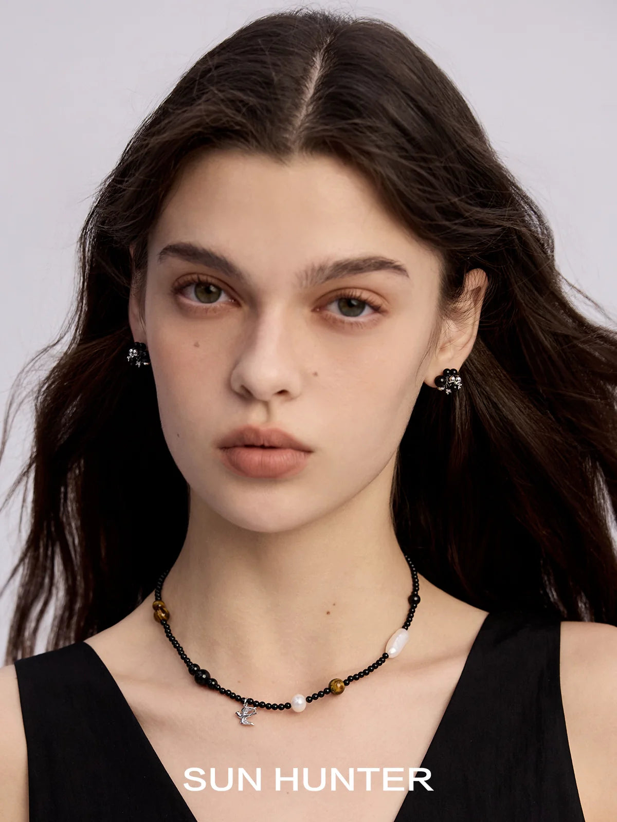 Elegant black agate earrings paired with a beaded necklace for a stylish look