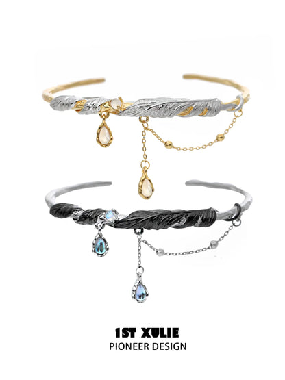 Stylish black and gold feather couple bracelet featuring elegant design and dangling gemstones