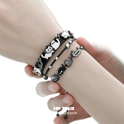 Set of black cat bracelets featuring playful designs and delicate charms for cat lovers
