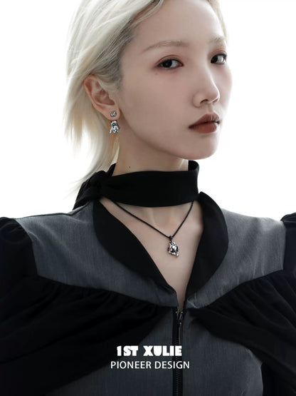 Fashion model wearing a black cat ghost necklace with matching earrings for a chic look