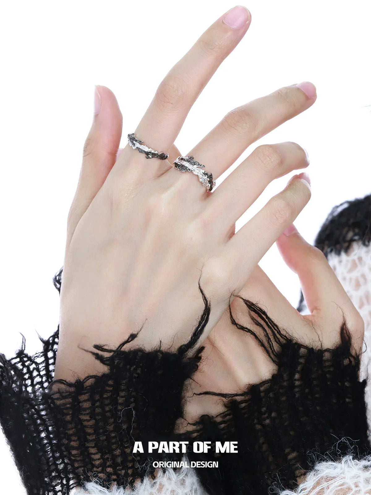 Two stylish rings worn on fingers, featuring a unique black contrast ring design for modern fashion lovers