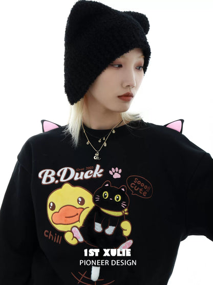 Model wearing a black gold cat necklace with a cozy sweater and cute cat ear hat