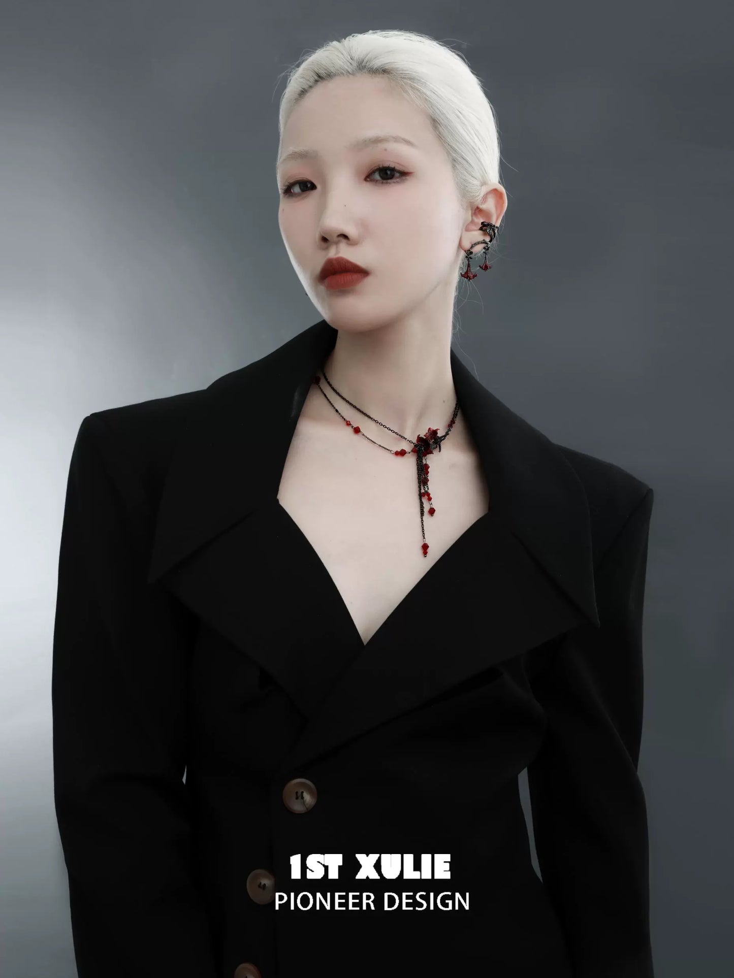 Elegant model wearing a blood mandala tassel necklace with intricate design and red accents