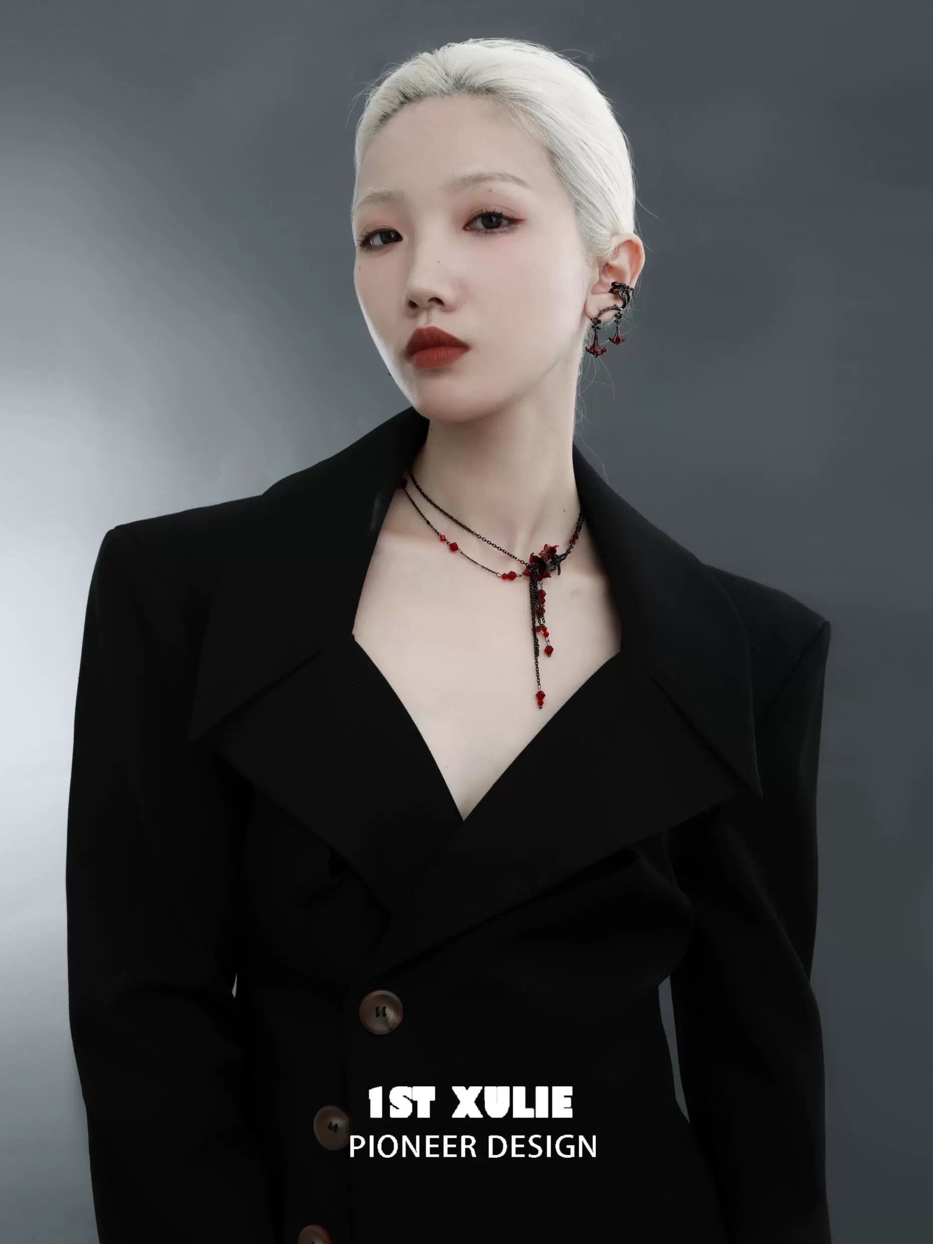 Elegant model wearing a blood mandala tassel necklace with intricate design and red accents