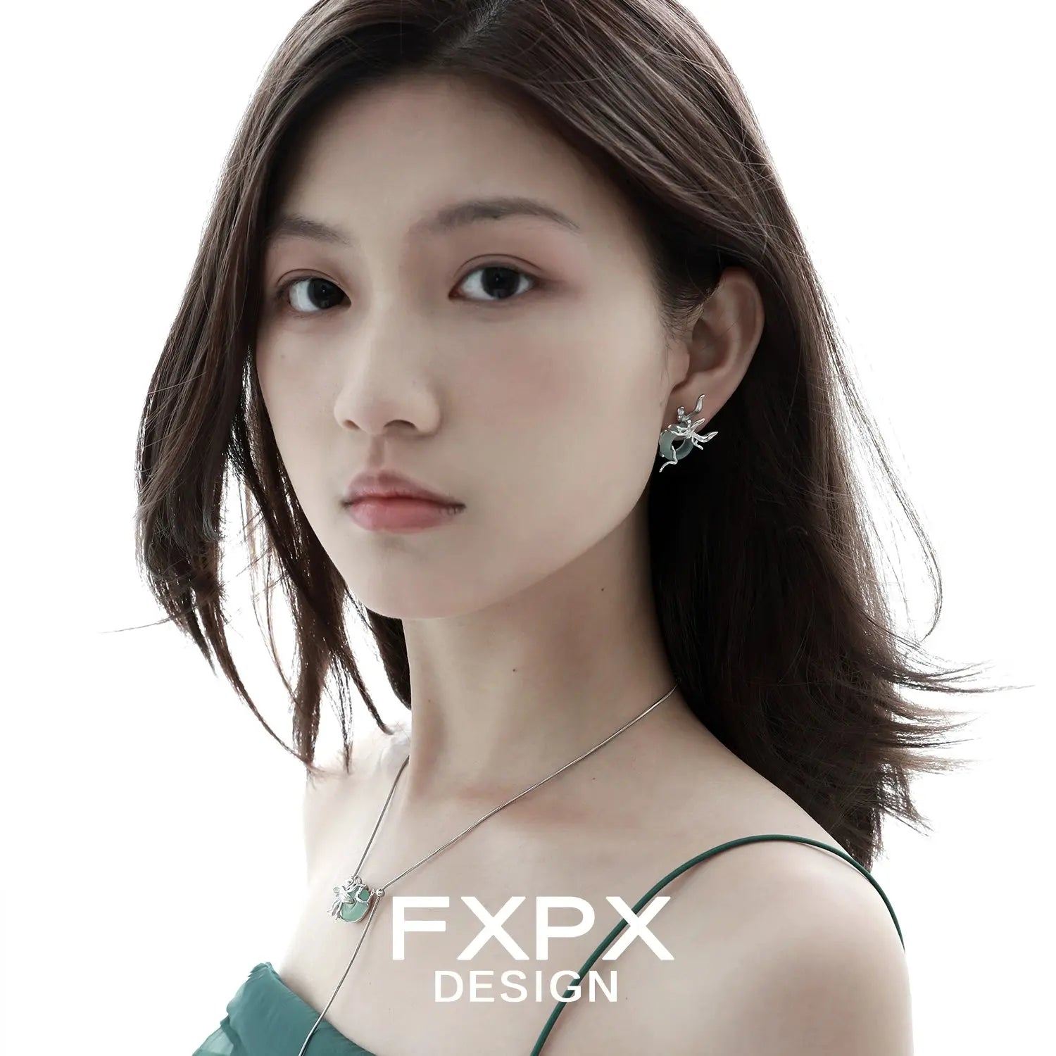 Woman wearing unique jade earrings for women by FXPX with matching necklace and green dress