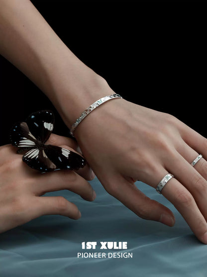 Elegant blue butterfly silver bracelet showcased on a woman's wrist with a striking black butterfly
