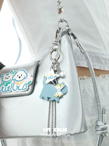 Blue cat keychain necklace with charms attached to a silver handbag for stylish accessories