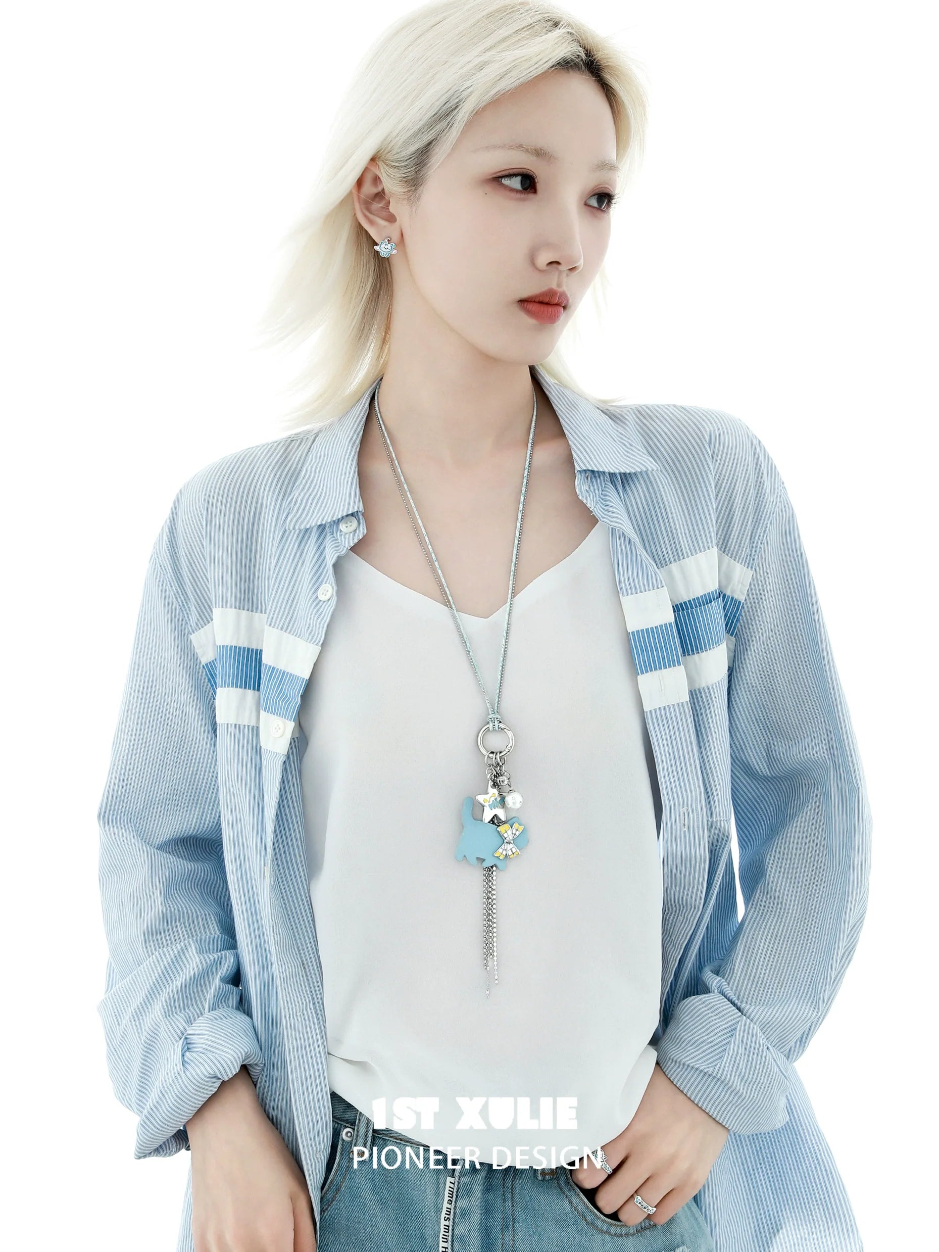 Stylish model wearing a blue cat keychain necklace with stars and silver chain for a trendy look
