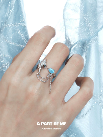 A PART OF ME silver ring featuring a blue conch chain ring design, elegantly worn on a hand
