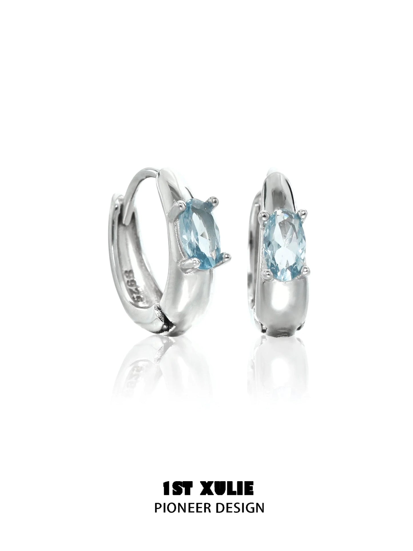Elegant 1STXULIE blue cosmic earrings featuring sparkling gemstones in a sleek silver setting