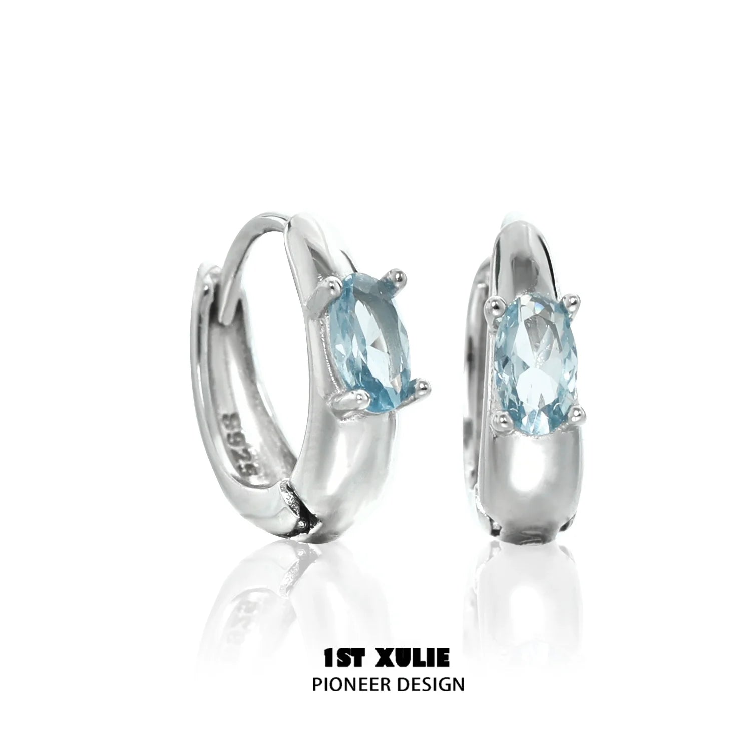 Elegant blue cosmic earrings with sparkling gemstone set in shiny silver hoop design