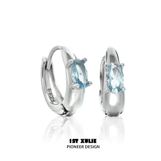 Elegant blue cosmic earrings with sparkling gemstone set in shiny silver hoop design