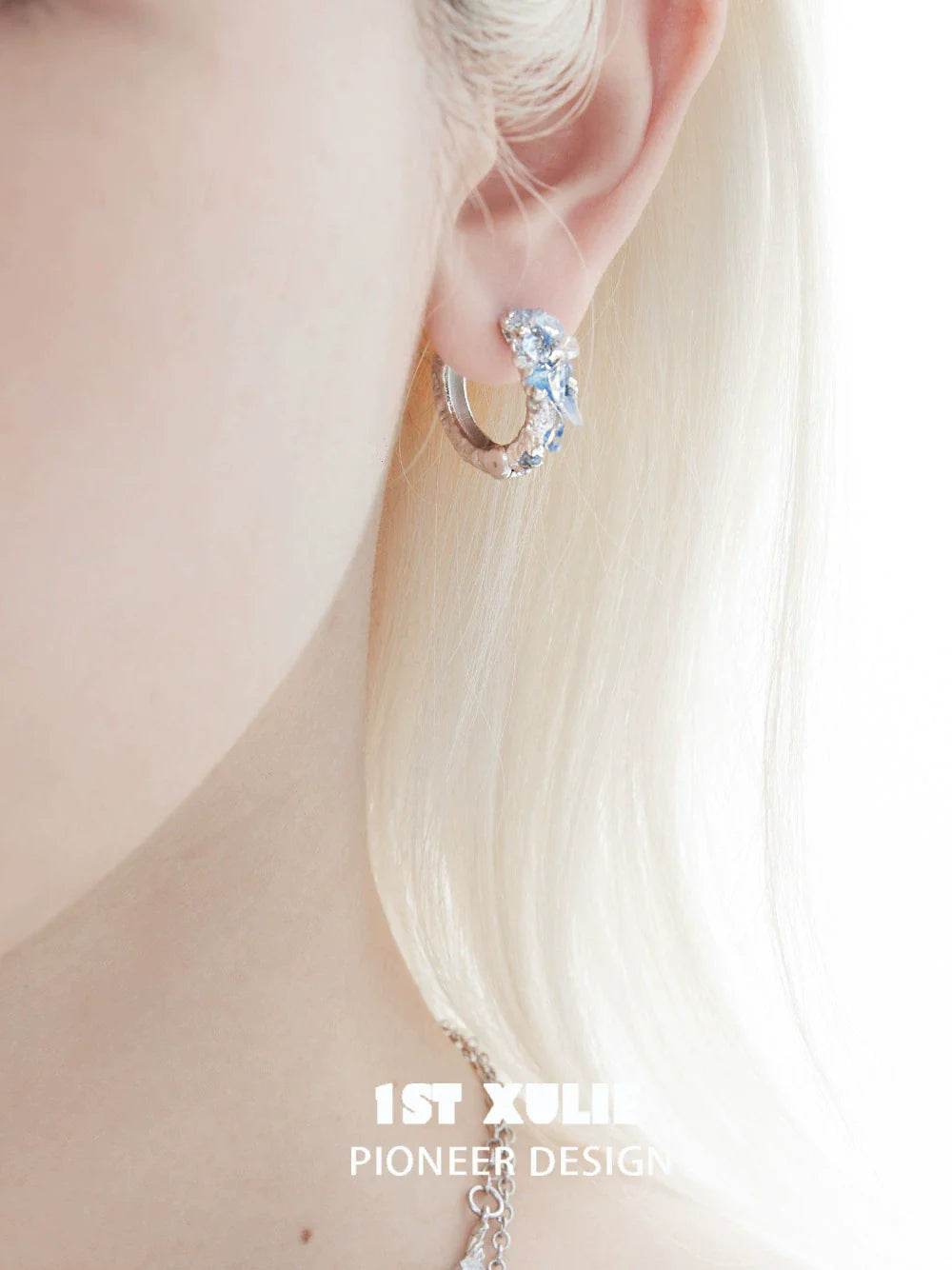 Elegant blue crystal ear cuffs from 1STXULIE showcasing a unique design and sparkle