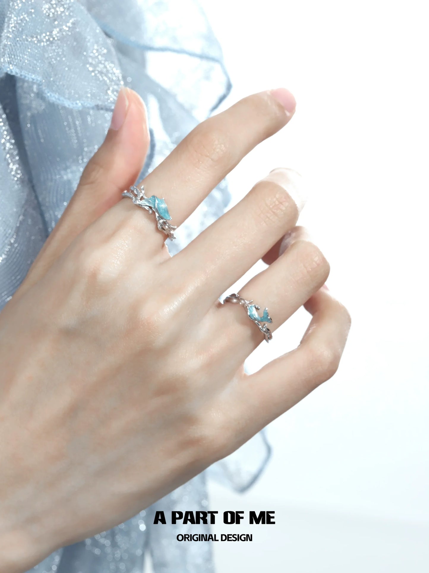 Elegant blue fishtail couple rings with intricate design worn on fingers