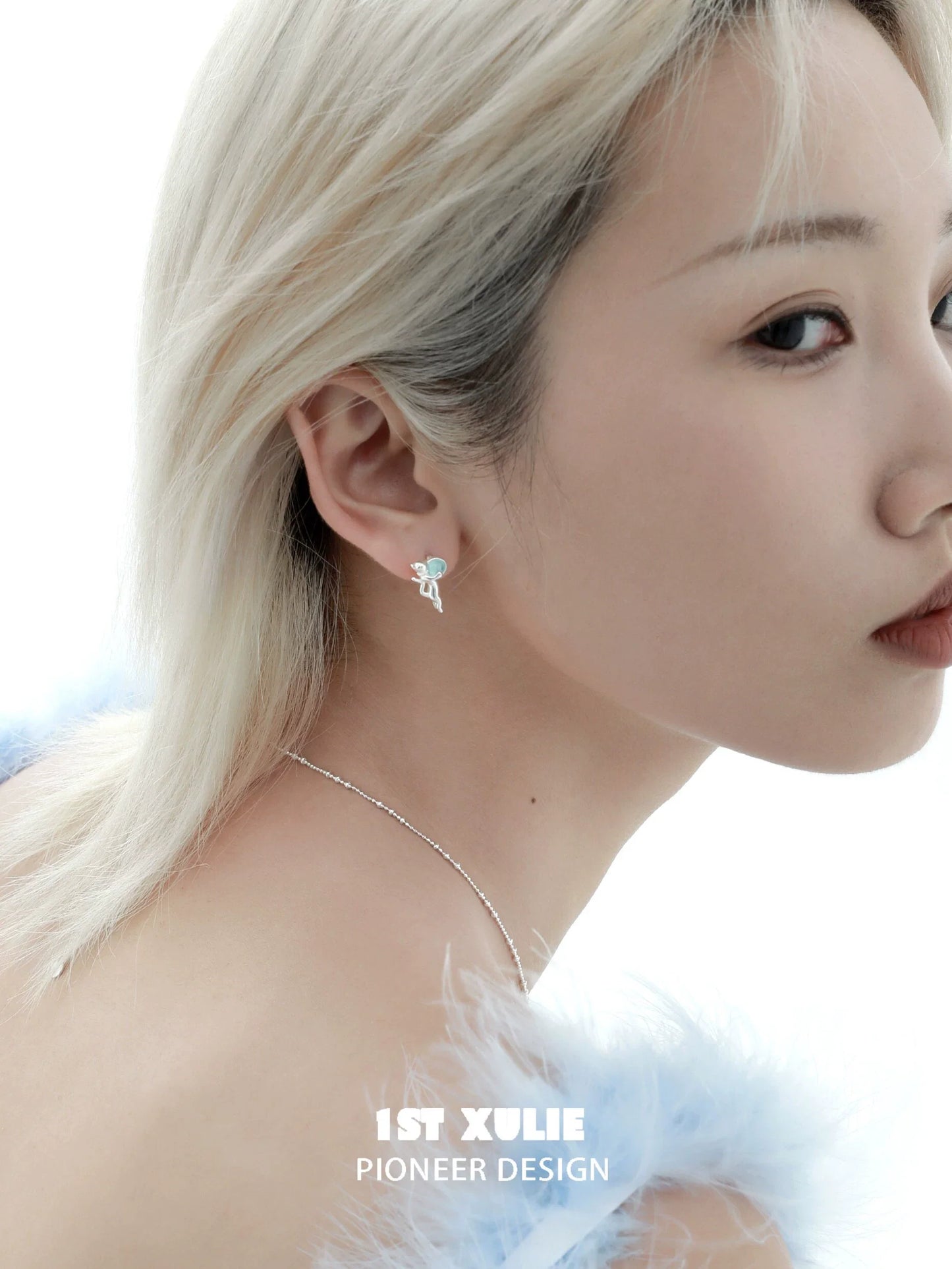 Stylish blue kitten earrings for women showcased on model with short hair in elegant setting