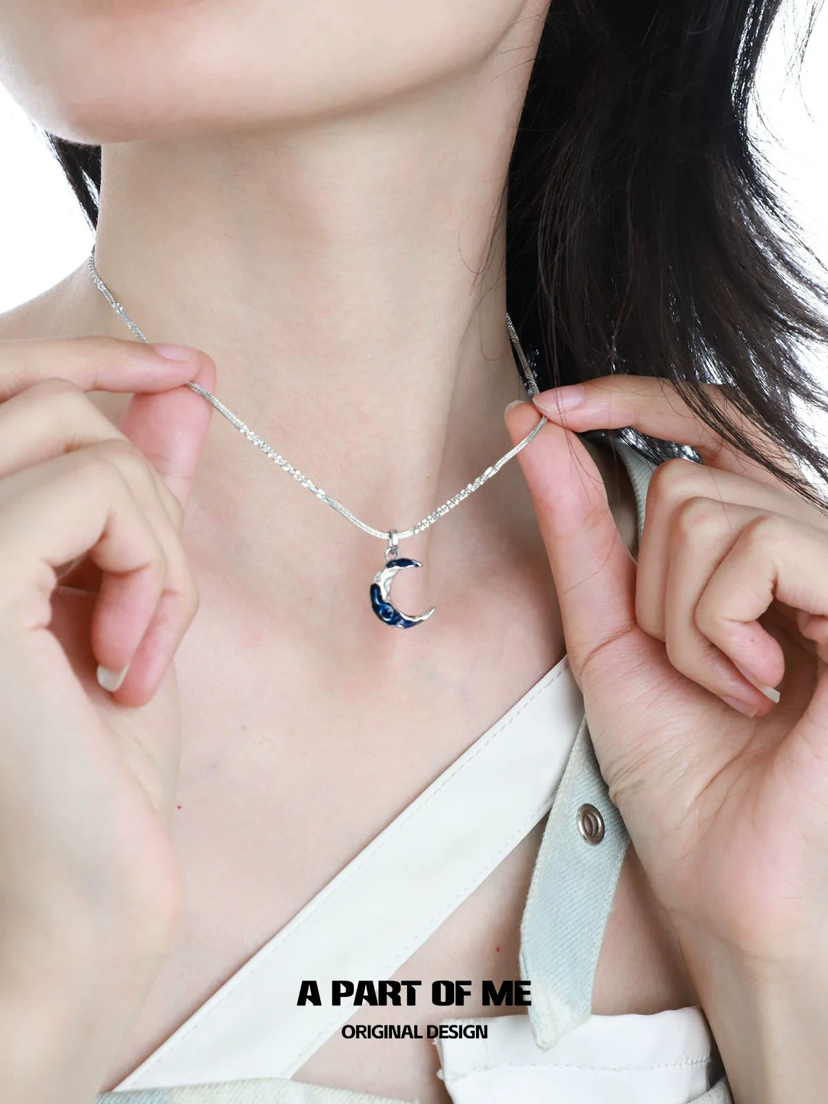 Model showcasing a blue moon pendant necklace with silver chain design for a stylish look