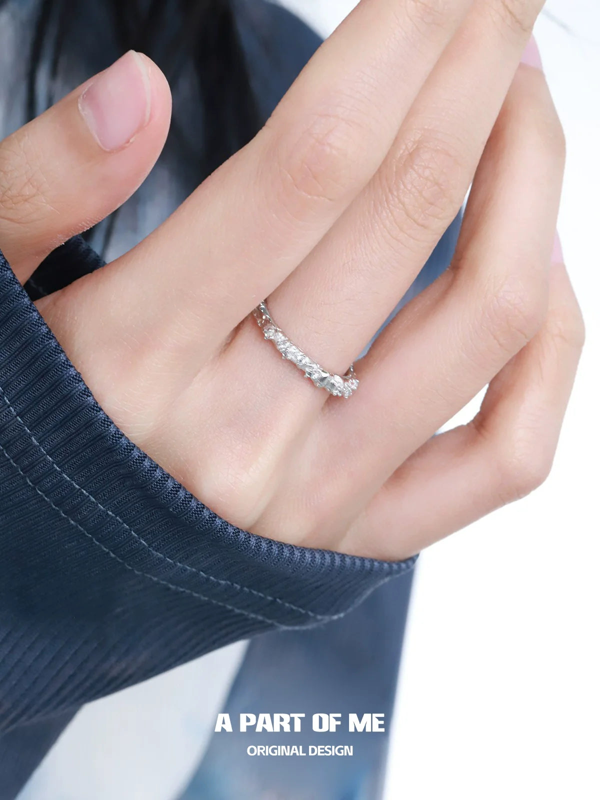 A PART OF ME blue star shard zircon ring elegantly displayed on a hand with delicate fingers