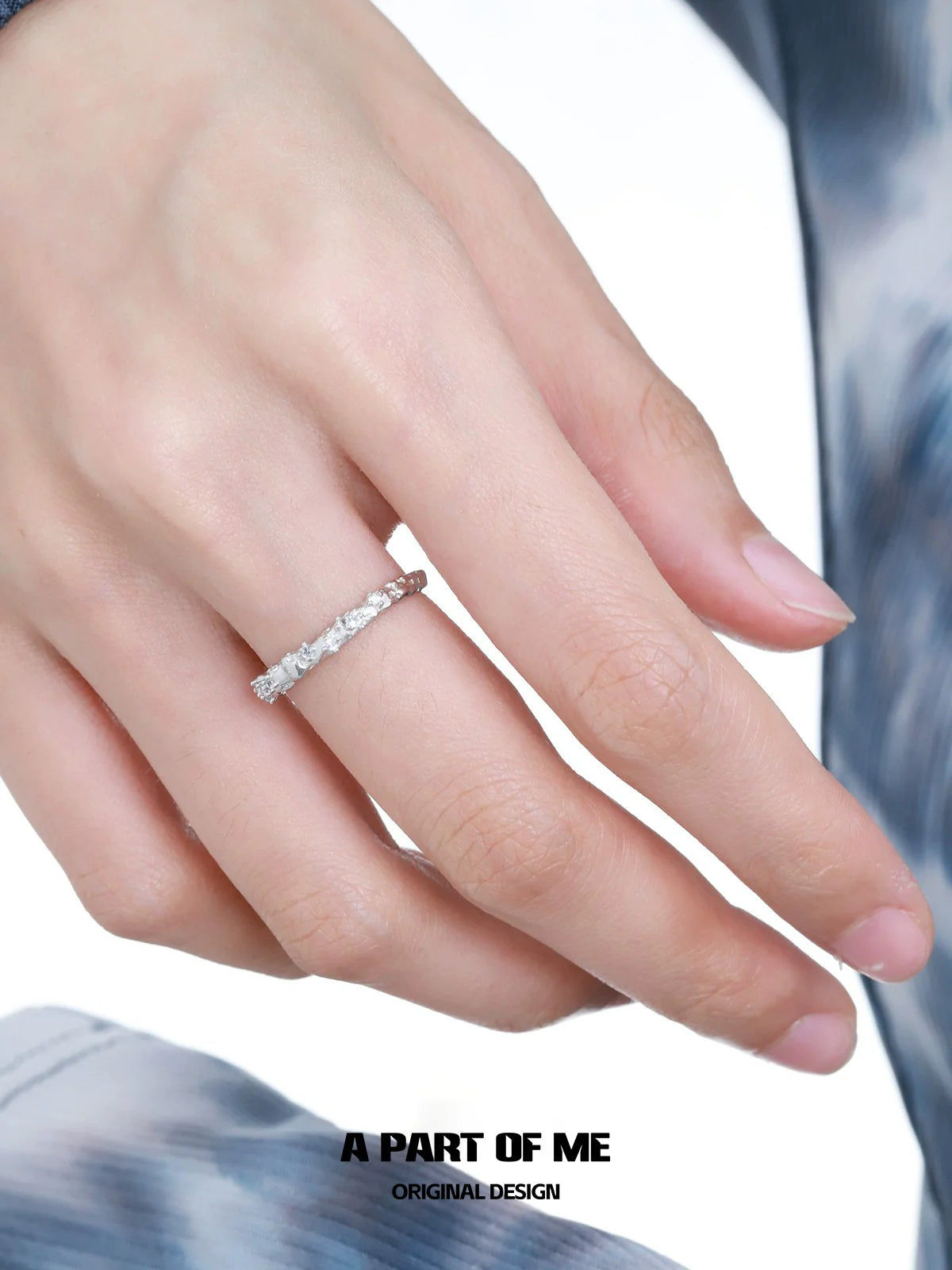 Elegantly designed blue star shard zircon ring worn on a woman's finger, showcasing its unique sparkle