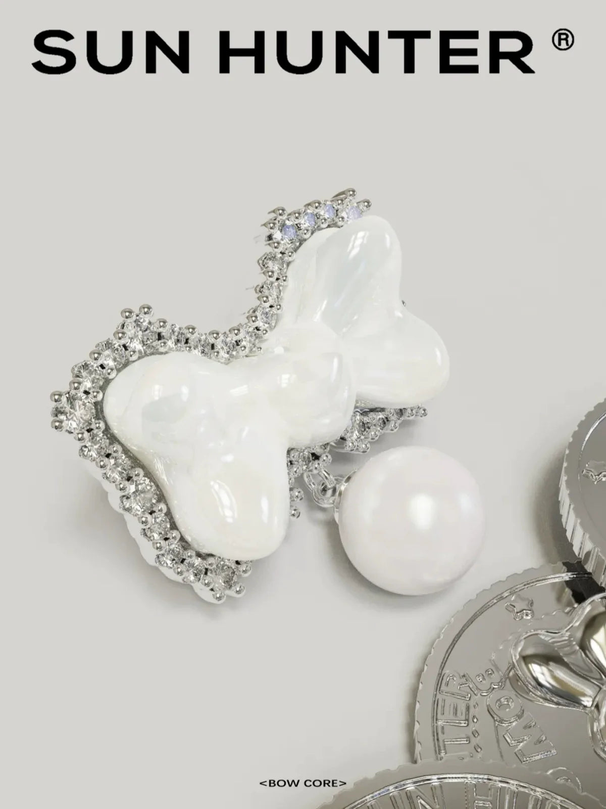 SUN HUNTER bow pearl earrings featuring a bow design with a pearl accent and sparkling details