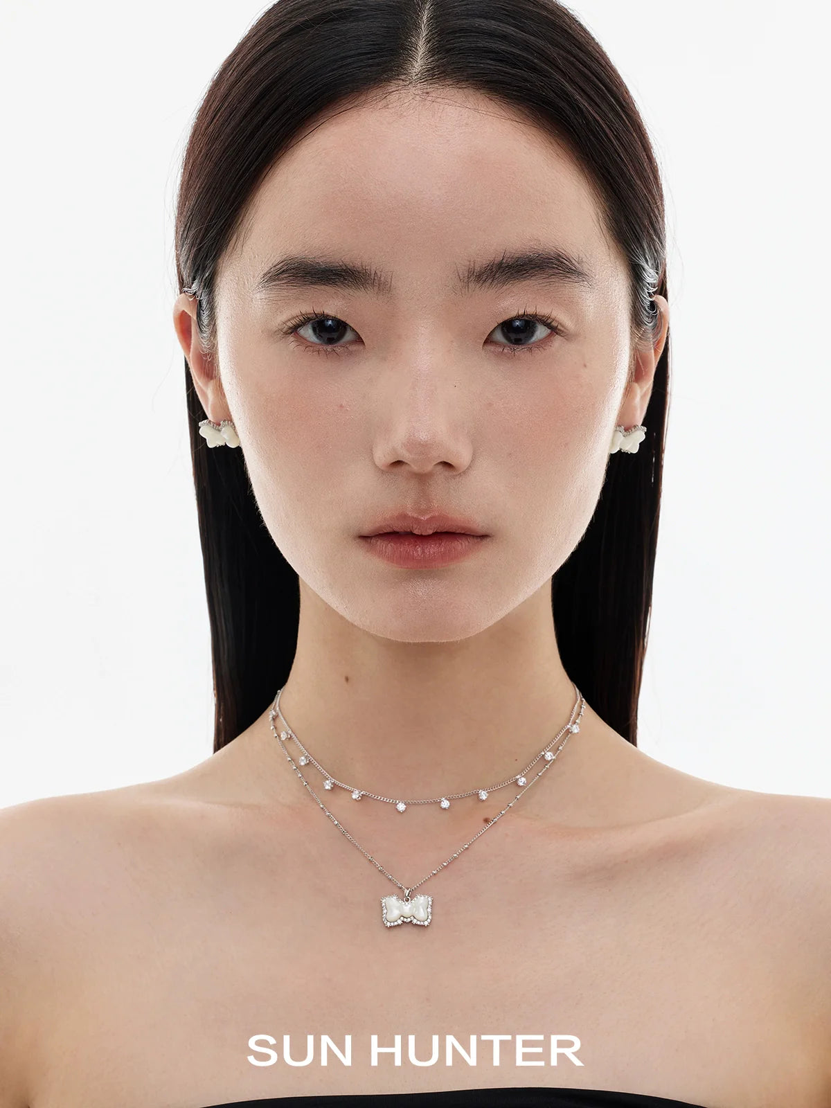 SUN HUNTER Bow Pearl Earrings that add elegance to any outfit with their unique design