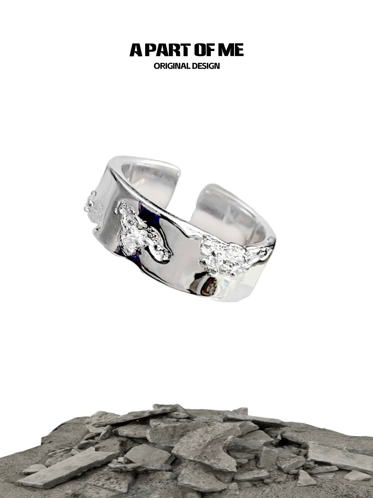 A PART OF ME broken silver ring with unique texture and original design showcased on a rocky background