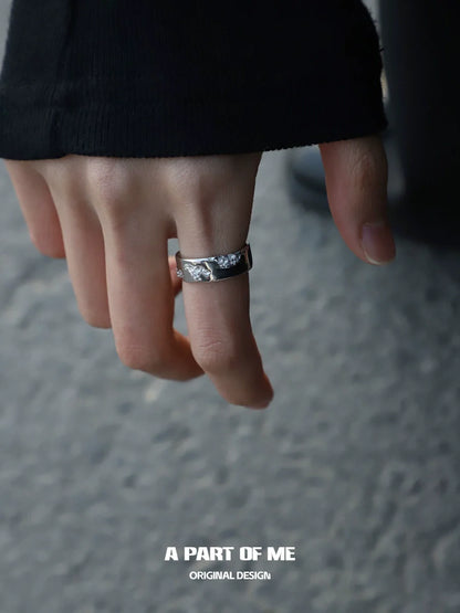 A PART OF ME broken silver ring displayed on a hand with casual attire