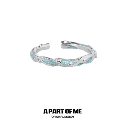 A PART OF ME broken starry sky ring with a textured silver design and blue accents