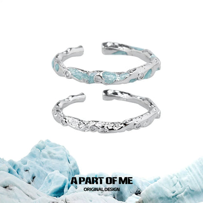 A PART OF ME broken starry sky ring with a textured silver design and blue gemstone accents