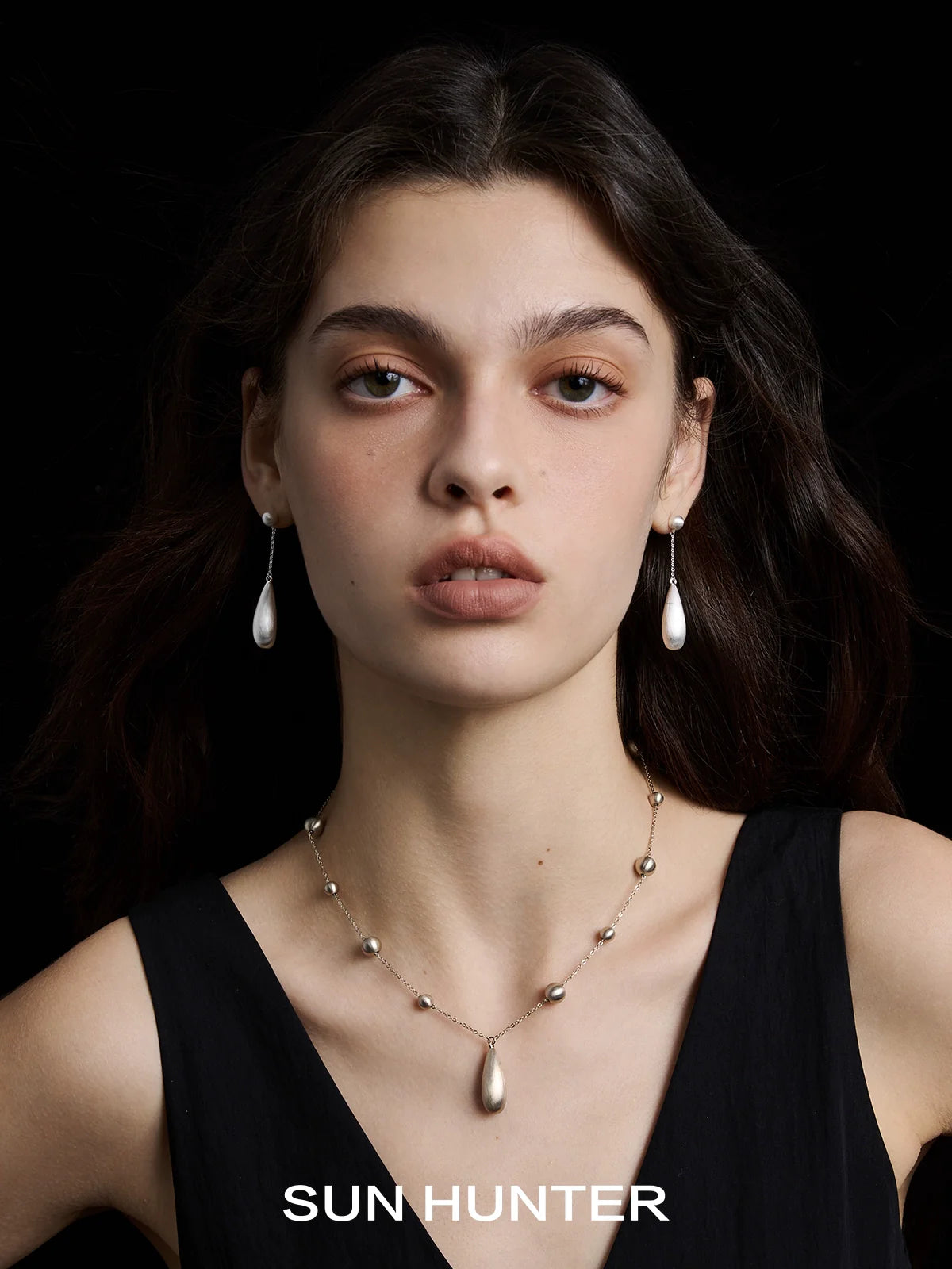 Elegant brushed teardrop earrings from SUN HUNTER, perfect for enhancing any outfit