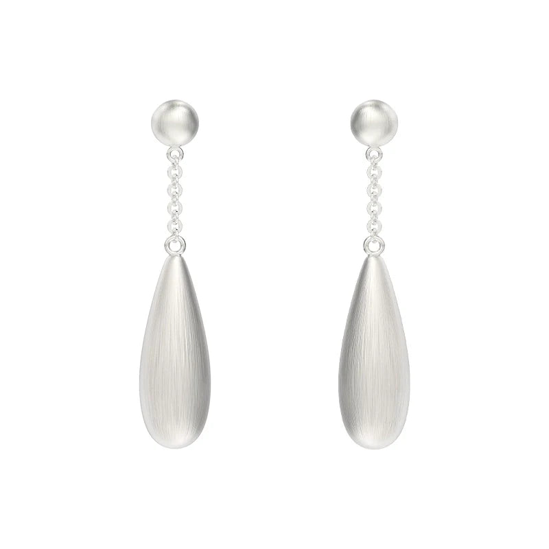 Elegant brushed teardrop earrings by SUN HUNTER with sleek silver finish and hanging design