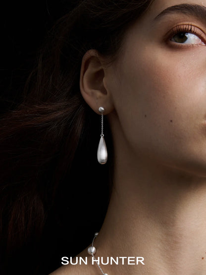 Elegant SUN HUNTER brushed teardrop earrings featuring a delicate silver design for a sophisticated look
