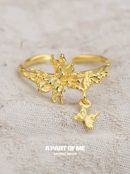 Elegant butterfly charm silver ring featuring intricate detailing and a delicate butterfly pendant