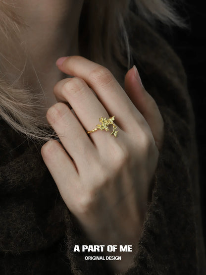 Delicate butterfly charm silver ring showcased on a hand with soft lighting