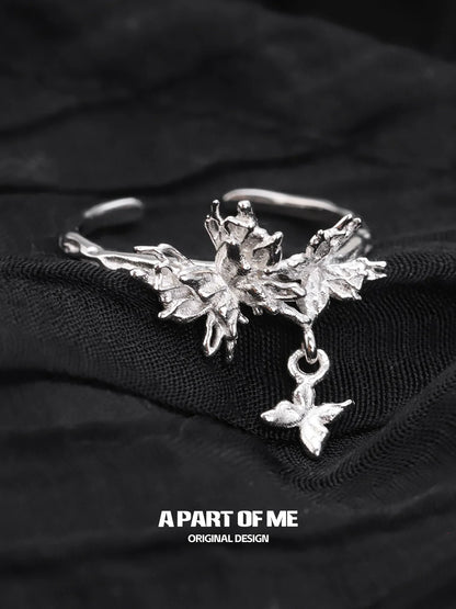 A PART OF ME butterfly charm silver ring featuring intricate floral designs and a delicate butterfly pendant