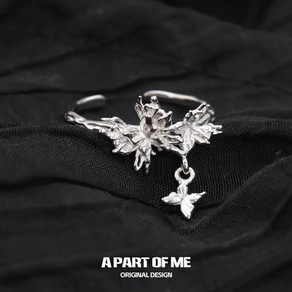 A PART OF ME butterfly charm silver ring with intricate leaf design and dangling butterfly charm