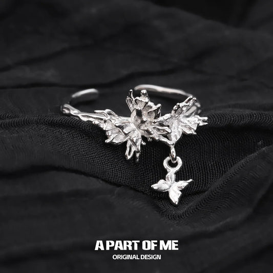 A PART OF ME butterfly charm silver ring with intricate leaf design and dangling butterfly charm