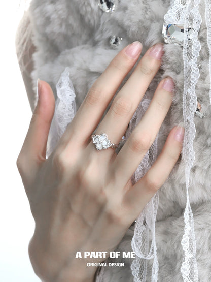 Elegant butterfly clover silver ring showcased on a model's hand with a soft background