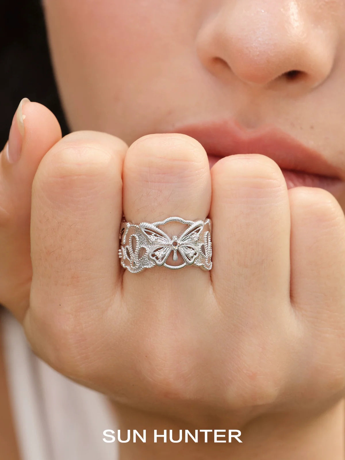 Silver SUN HUNTER butterfly hollow ring showcasing intricate butterfly designs on a delicate band