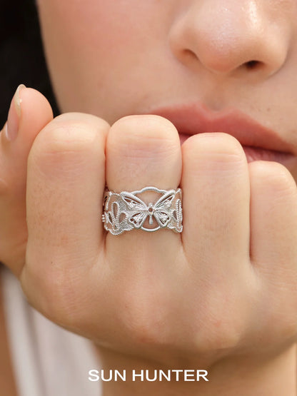 Silver SUN HUNTER butterfly hollow ring showcasing intricate butterfly designs on a delicate band