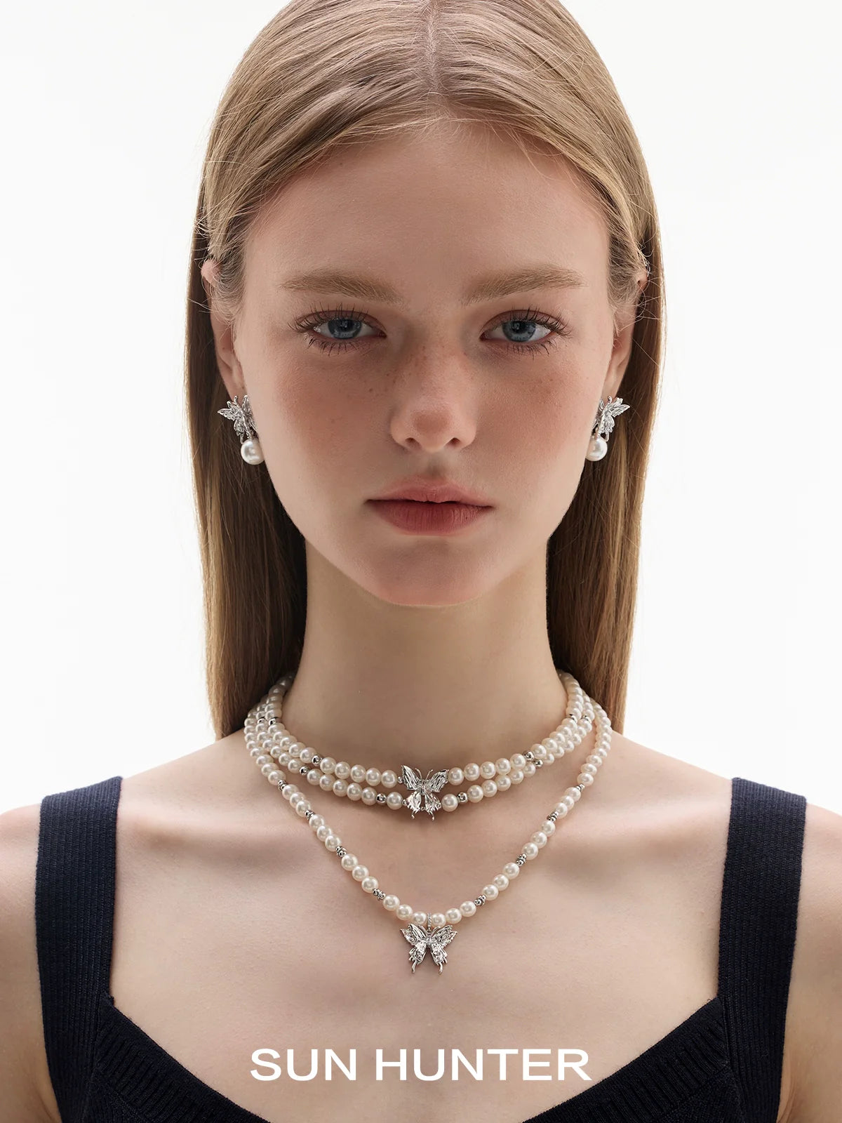 Elegant butterfly pearl earrings paired with matching pearl necklace from SUN HUNTER collection
