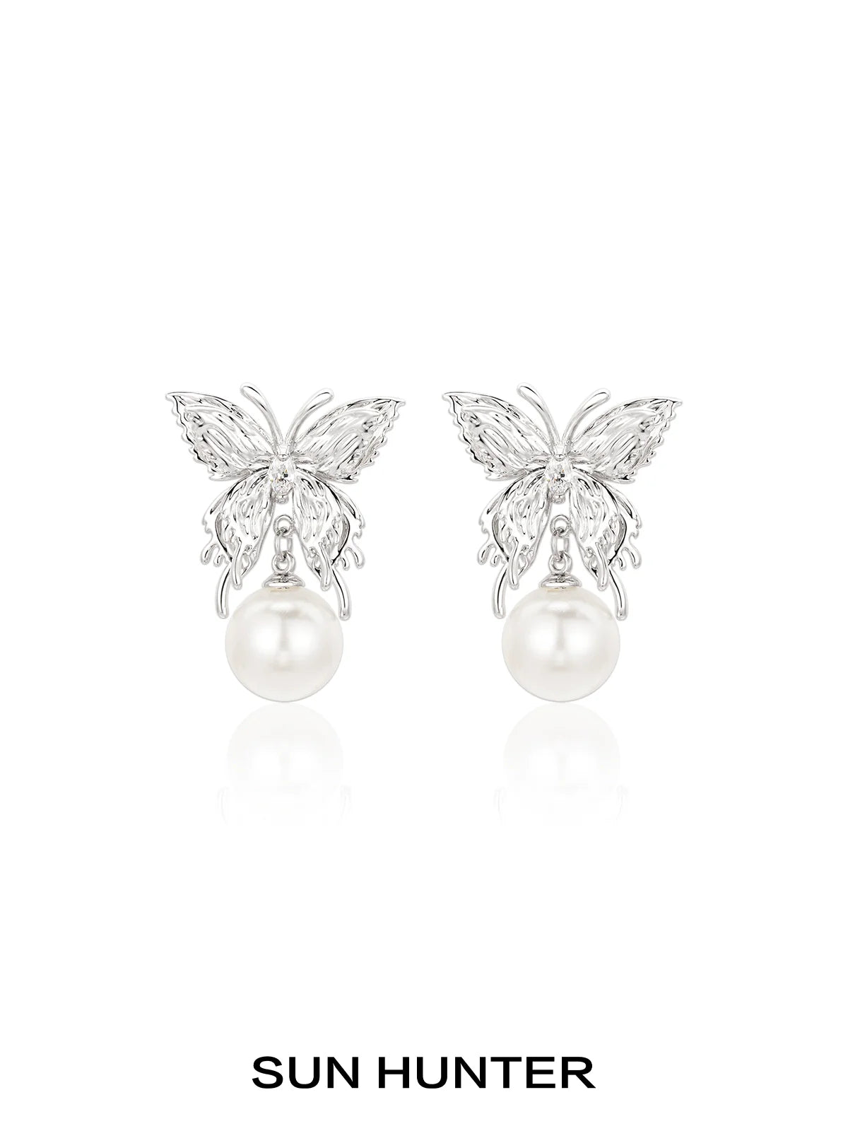 Elegant SUN HUNTER butterfly pearl earrings featuring a silver butterfly design and lustrous pearls