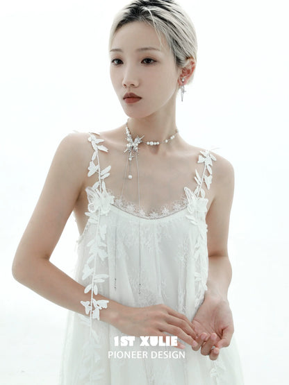 Elegant butterfly pendant necklace from 1STXULIE worn with a delicate white dress