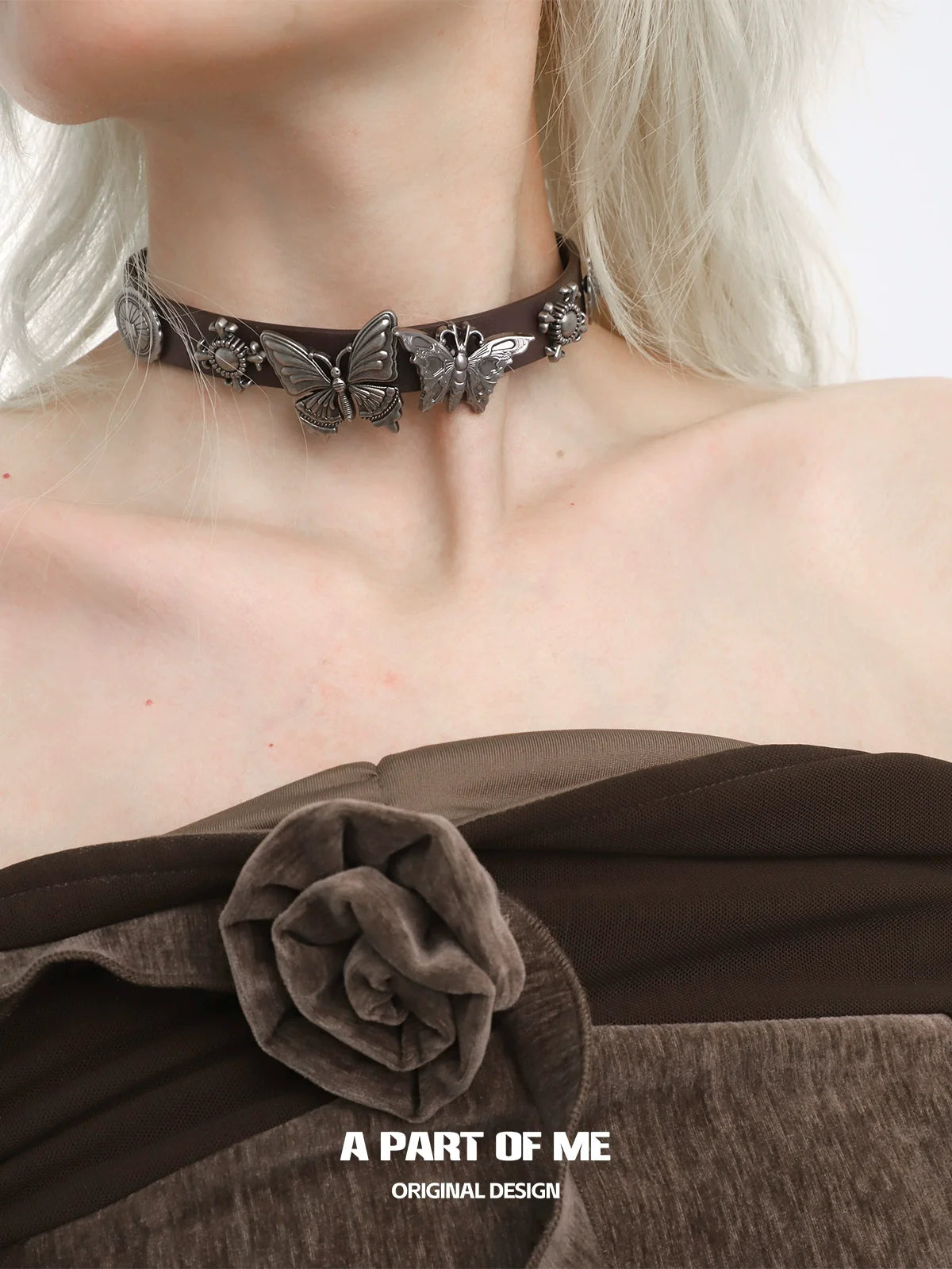 A Part of Me butterfly punk necklace featuring silver butterfly charms on a brown choker style