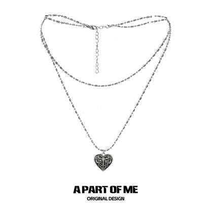 Butterfly punk necklace with layered silver chains and a heart pendant for edgy style