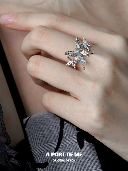 Silver A PART OF ME butterfly punk ring featuring intricate crystal detailing on a hand model