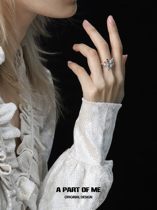 A PART OF ME butterfly punk ring showcased on a model's hand with elegant dress details